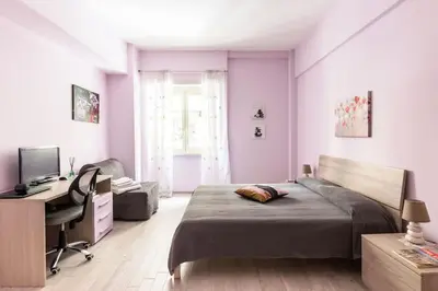 a bedroom with a bed and a desk and a computer at la casetta dei sogni in Rome