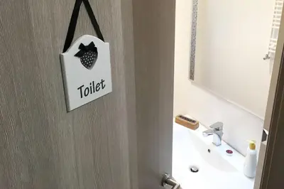 a white bathroom door with a toilet sign on it at la casetta dei sogni in Rome