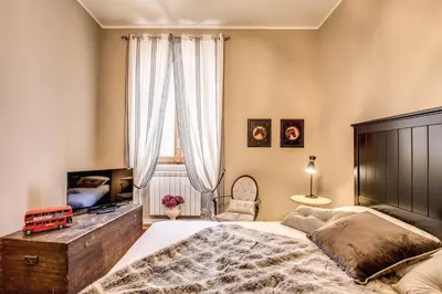 a bedroom with a bed and a flat screen tv at Spanish Steps Miracle Suite in Rome