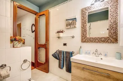 a bathroom with a sink and a mirror at Spanish Steps Miracle Suite in Rome