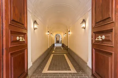an empty hallway in a building with lights on the walls at Spanish Steps Miracle Suite in Rome