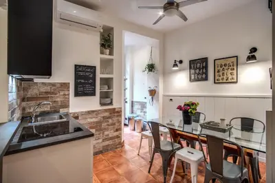 a kitchen with a counter and a table with chairs at Spanish Steps Miracle Suite in Rome