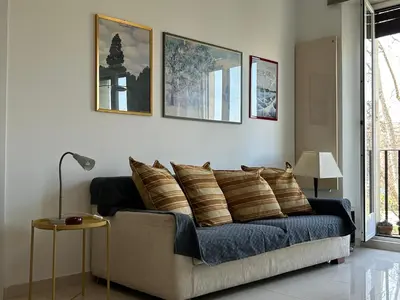 a living room with a couch with pillows on it at La Riva Sinistra in Rome