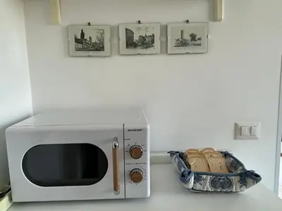 a microwave on a counter with a basket of bread at La Riva Sinistra in Rome