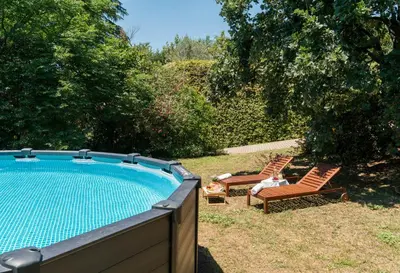 a backyard with a swimming pool and two lawn chairs at Domus Quiritum Villa in Rome