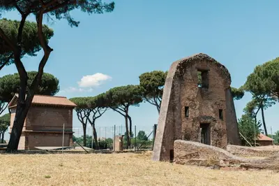 an old stone building with trees in the background at Domus Quiritum Villa in Rome