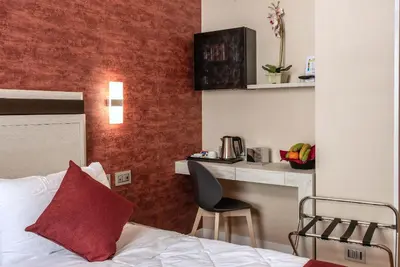 a hotel room with a bed and a desk at Hotel Memphis in Rome