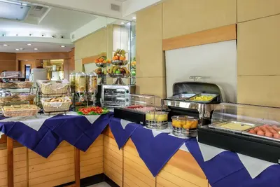 a buffet line with food on display in a restaurant at Hotel Memphis in Rome