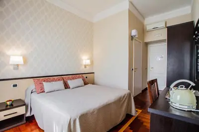 a bedroom with a bed and a table and a tea kettle at Domus Palatina in Rome