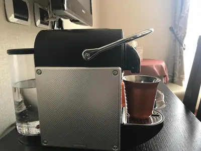 a coffee maker on a table with a cup of coffee at Domus Palatina in Rome