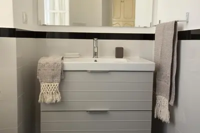 a bathroom with a sink and a mirror at Colosseum View Exclusive Apartment in Rome