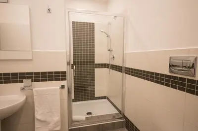 a bathroom with a shower and a sink at Trastevere Sweet Dream in Rome