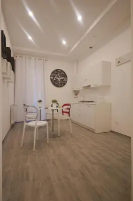 a kitchen with a table and chairs in a room at Trastevere Sweet Dream in Rome