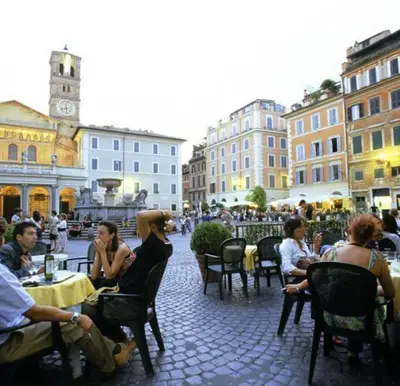 a group of people sitting at tables in a city at Trastevere Sweet Dream in Rome