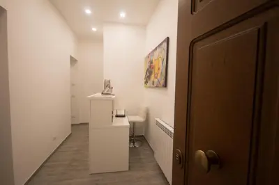 a hallway with a desk and a painting on the wall at Trastevere Sweet Dream in Rome