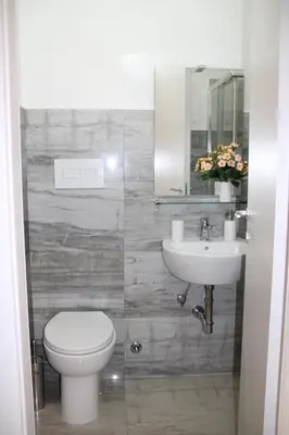 a bathroom with a toilet and a sink and a mirror at My Rhome Prati in Rome