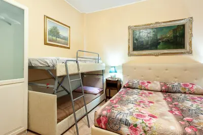 a bedroom with a bed and two bunk beds at Vatican Mami in Rome