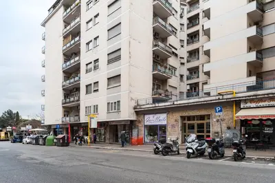 a tall white building with motorcycles parked in front of it at Vatican Mami in Rome