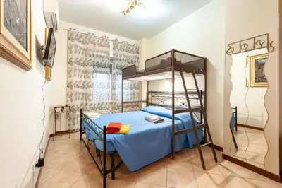 a bedroom with a bunk bed with a blue bedspread at Vatican Mami in Rome
