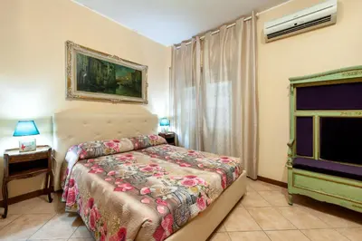 a bedroom with a bed and a television in it at Vatican Mami in Rome