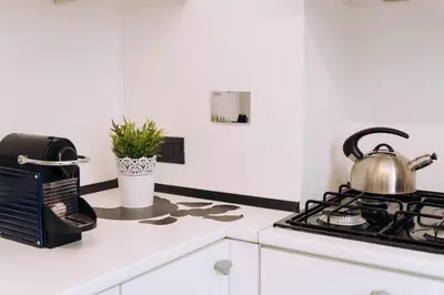 a tea kettle sitting on top of a stove in a kitchen at Duke's Apartment in Rome