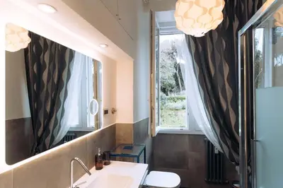 a bathroom with a sink and a mirror at Duke's Apartment in Rome