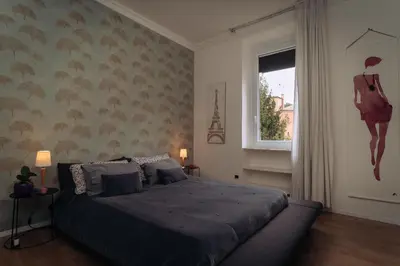 a bedroom with a bed and a window at Duke's Apartment in Rome