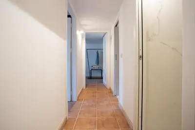 a hallway with a tile floor and white walls at PgrHome Domus Pantheon in Rome