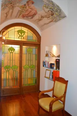 a room with a door with a stained glass window at La Petite Maison Piave in Rome