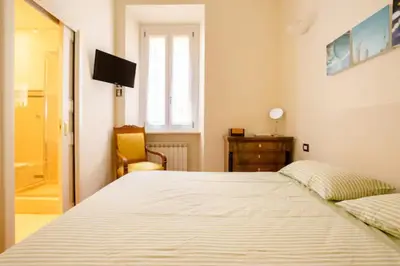 a bedroom with a large bed and a window at La Petite Maison Piave in Rome
