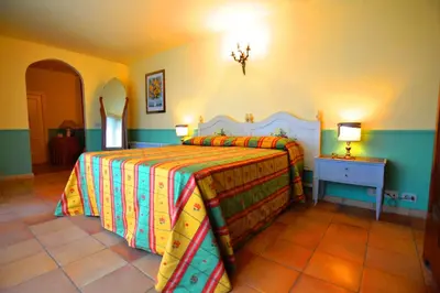 a bedroom with a bed with a colorful bedspread at Relais La Canfora in Rome