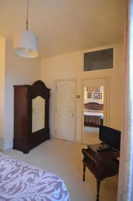 a bedroom with a bed and a table and a piano at Relais La Canfora in Rome