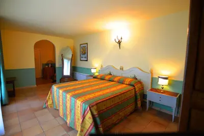 a bedroom with a bed with a colorful bedspread at Relais La Canfora in Rome