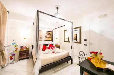 a bedroom with a bed with a canopy at Suites Roma Tiburtina in Rome