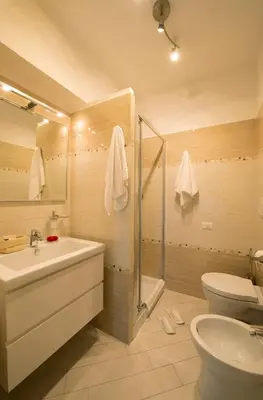 a bathroom with a sink and a toilet and a shower at Suites Roma Tiburtina in Rome