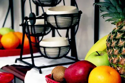 a fruit stand with bowls of fruit on a table at Suites Roma Tiburtina in Rome