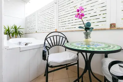 a table with a flower in a vase on it in a kitchen at Suites Roma Tiburtina in Rome