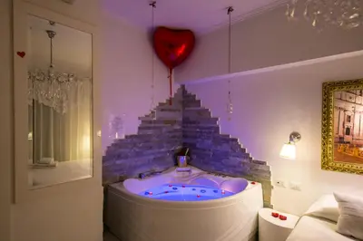 a hot tub in a room with a staircase at Suites Roma Tiburtina in Rome