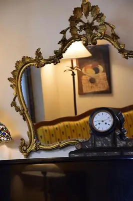 a clock sitting on a table in front of a mirror at Hotel Lancelot in Rome