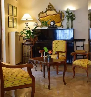 a living room with a piano and a table and chairs at Hotel Lancelot in Rome