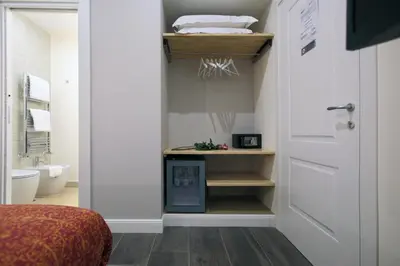 a hallway with a door and a room with a bathroom at Trevi Contemporary Suite in Rome