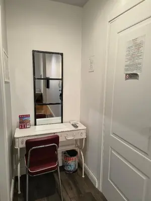 a bathroom with a vanity with a mirror and a chair at Trevi Contemporary Suite in Rome