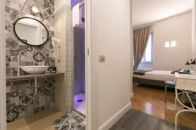 a bathroom with a sink and a mirror at Trevi Contemporary Suite in Rome