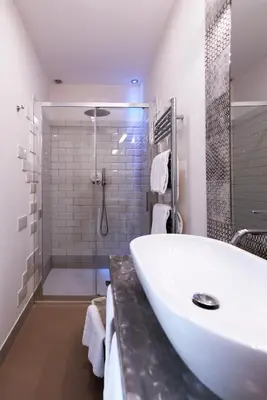 a bathroom with a large white tub and a shower at Trevi Contemporary Suite in Rome