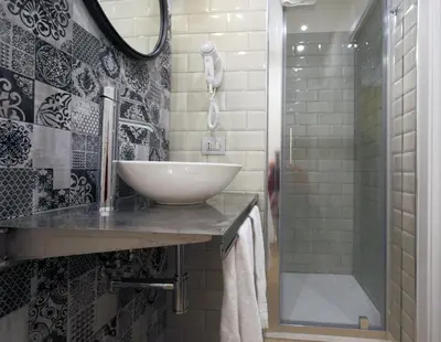 a bathroom with a sink and a shower at Trevi Contemporary Suite in Rome