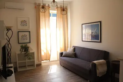 a living room with a blue couch and a window at Apartment Flaminio in Rome