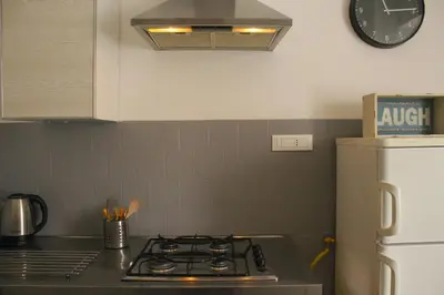 a kitchen with a stove and a clock on the wall at Apartment Flaminio in Rome