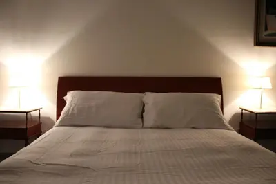 a bedroom with a bed with two lamps on both sides at Apartment Flaminio in Rome