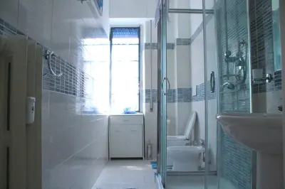 a bathroom with a sink and a toilet and a window at Apartment Flaminio in Rome