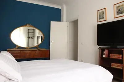a bedroom with a bed and a mirror and a tv at Apartment Flaminio in Rome